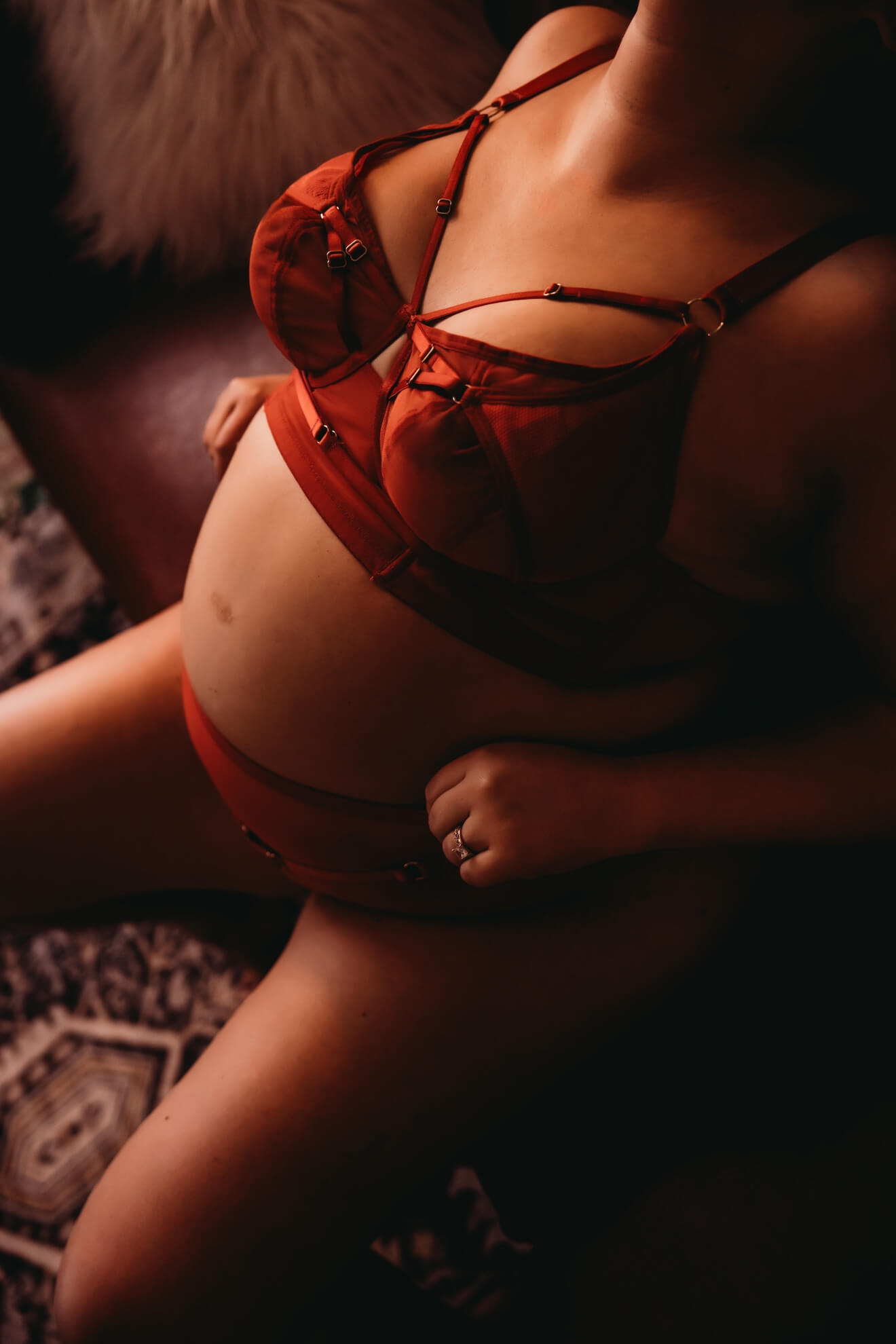 Maternity boudoir portrait in red lingerie