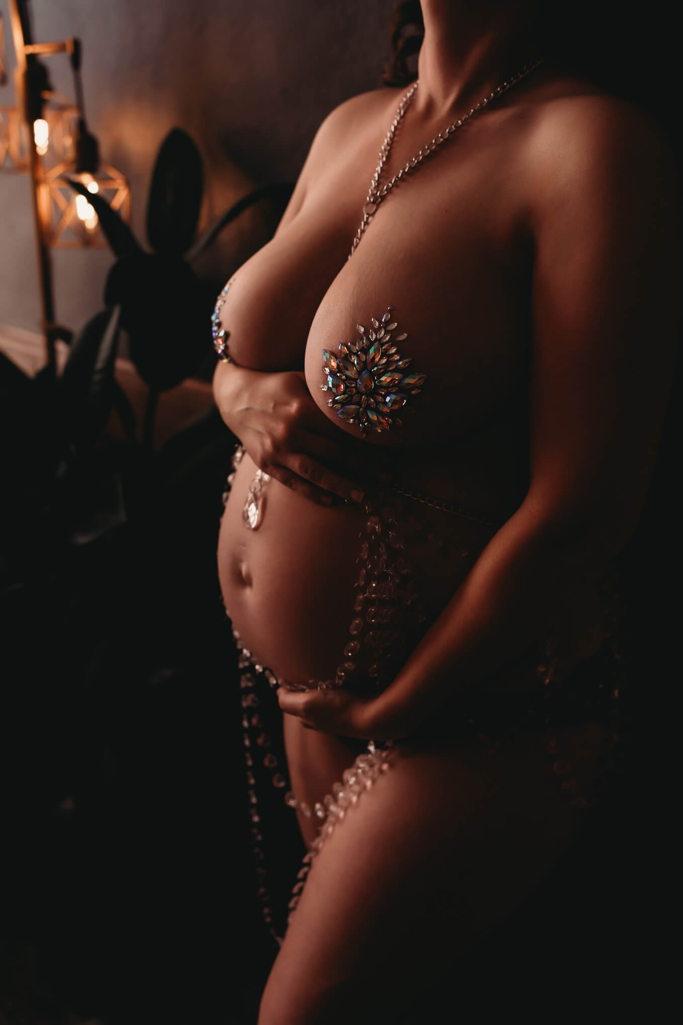 Maternity boudoir portrait with floral body adornment