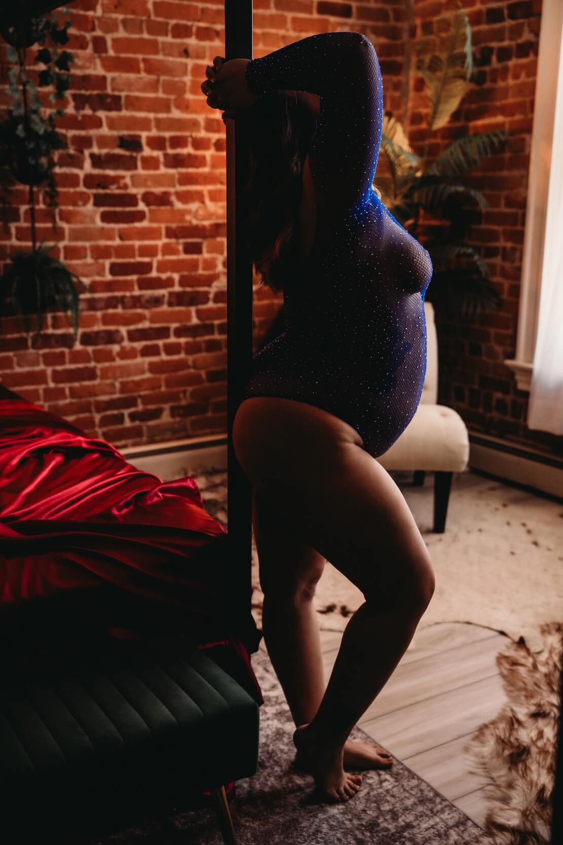 Standing maternity boudoir portrait in a private studio